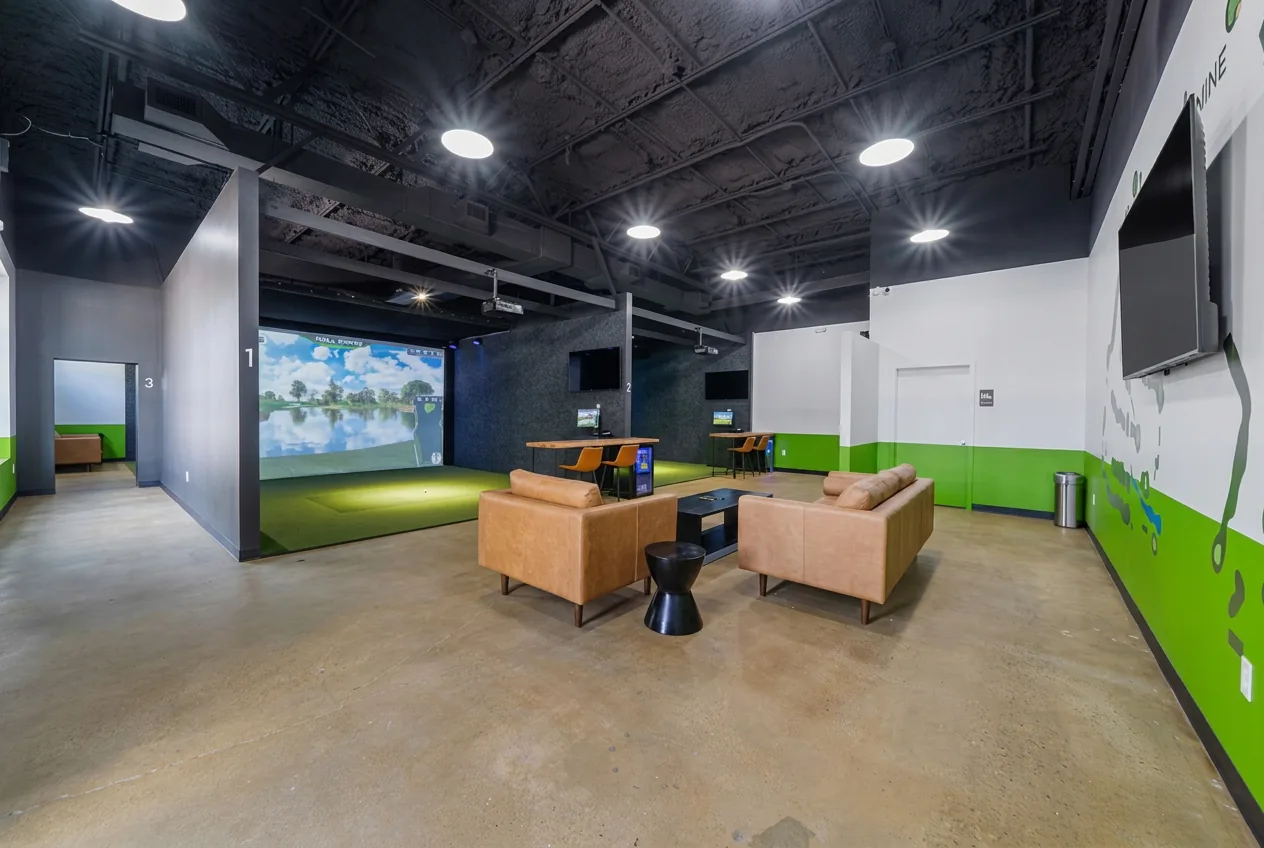 Members lounge with leather sofas and simulator bays at The Back Nine East Austin